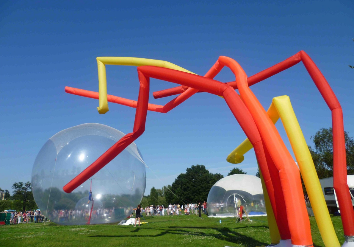 Giant sphere with dancer, and giant coloured tubes