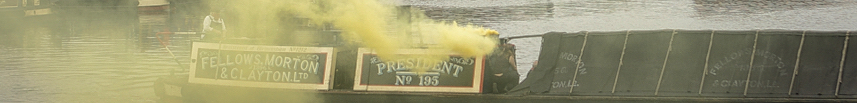 a barge with bright yellow smoke